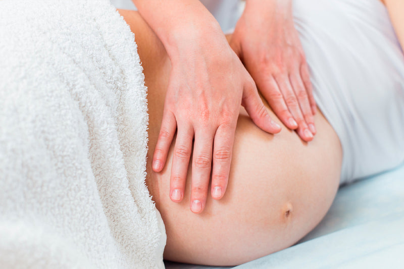 Woman receiving a prenatal massage and relaxing during pregnancy