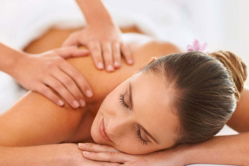 A woman receiving a massage on her upper body to relax and relieve tension 